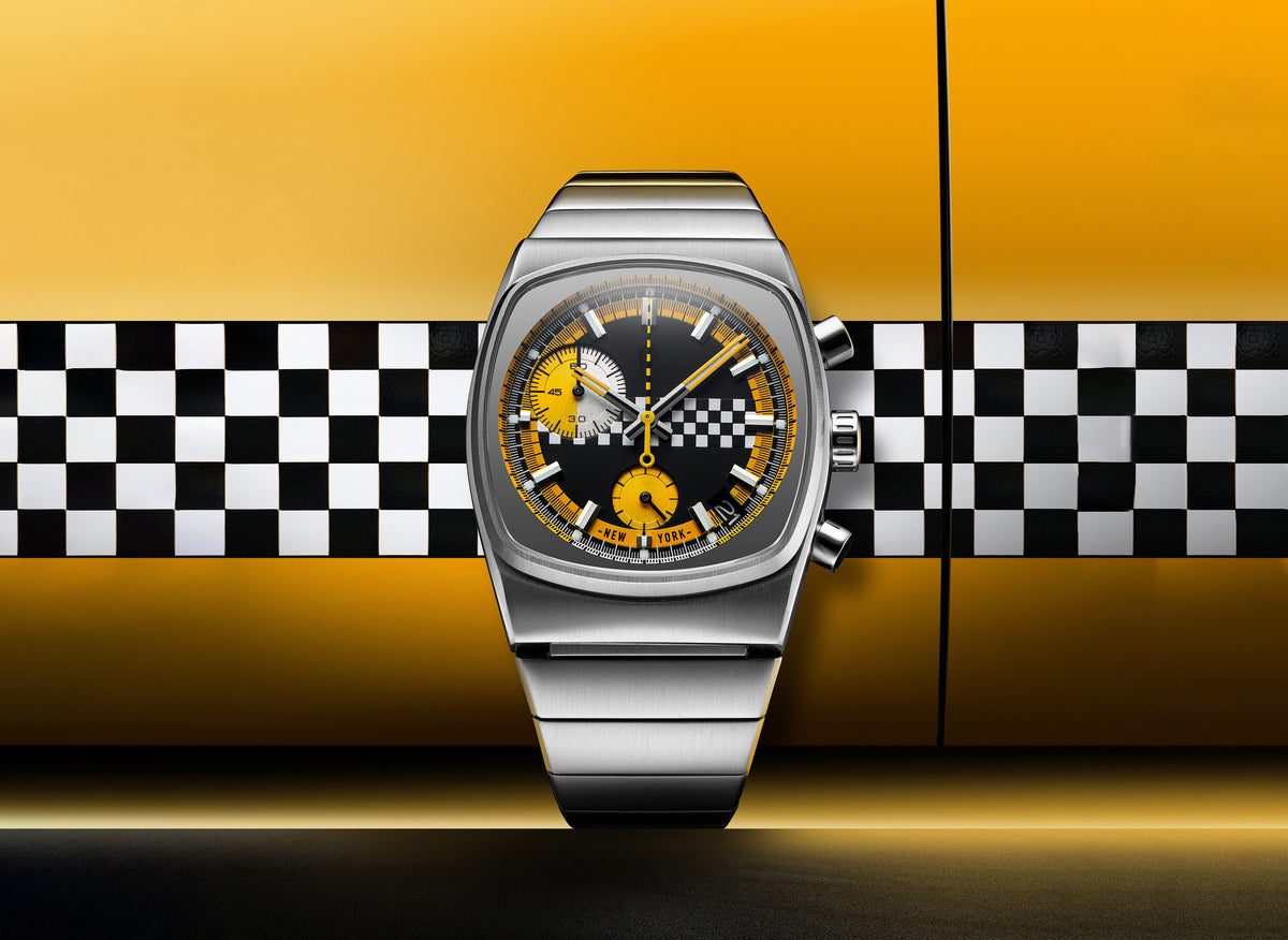 The Brew Metric Chrono Taxi's checkerboard dial photographed against New York taxi colours.